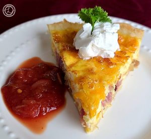 A slice of Gluten-Free Quiche with salsa and sour cream