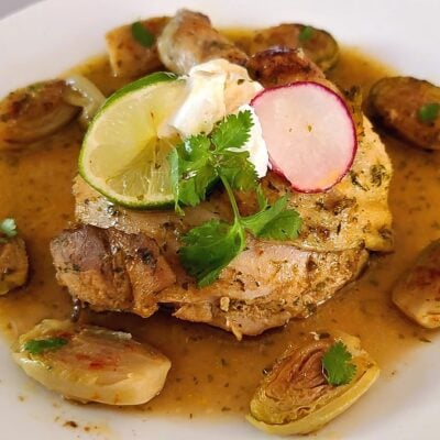 Cooked chicken Keto Zesty Jalapeno Chicken Quarter on a plate with a little pan juices
