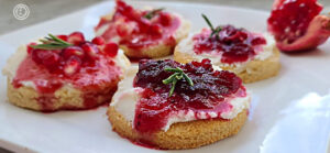 A plate of Cranberry Jam, Lingonberry Jam, and Pomegranate Seed decorated cookies