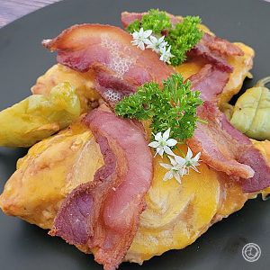 A picture of a close up of the chicken with cheese and bacon.