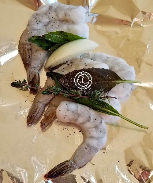 Italian Shrimp Foil-Pack Dinner is quick and easy to make. Place the ingredients into a sheet of tin foil add fresh herbs and garlic, crimp closed and bake. Shrimp with fresh herbs