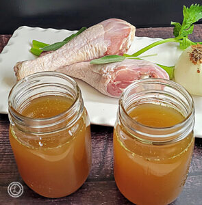 Turkey Bone Broth with Turkey Legs in the background