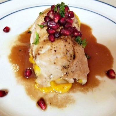 Chicken Roulade with Pomegranate Glaze and Pomegranate Pearls decorating the plate