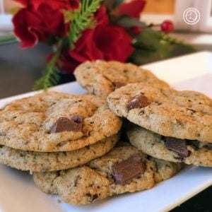 Gluten-Free Chopped Chocolate Cookies a bunch of cookies on a platter with roses in the background. A square photo.