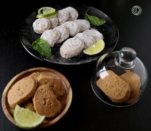 Cookies on plates and some under glass.