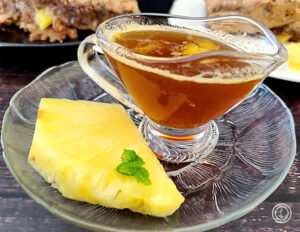 Pineapple Apple Syrup with gluten-free Pineapple Pancake Bars in the background