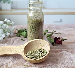 A small bottle and spoonful of the seasoning.