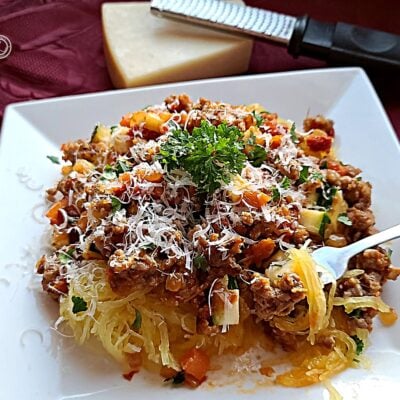 Gluten-Free Moroccan Spaghetti with Parmesan cheese in the background.