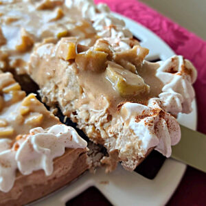 A piece being cut out of the Cinnamon Apple Caramel Cheesecake Recipe