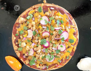 A picture of Gluten-Free Mexican Chicken Pizza on a pizza stone