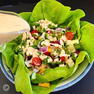 Southwest Salad Dressing on a salad on a bed of butter lettuce.