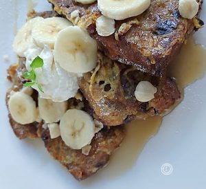 Gluten-Free Banana French Toast on a plate with bananas and syrup