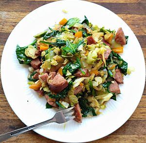 One Dish Sausage | Vegetables on a plate with a bite on the fork in front.