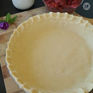 Gluten-Free Pie Crust unfilled on a cutting board.