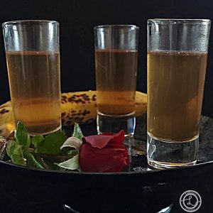 Refined Sugar-Free Banana Liqueur Recipe three glasses with a banana and a rose