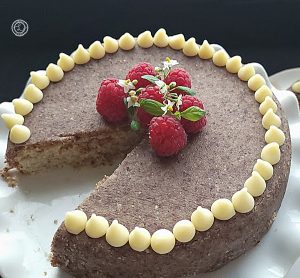 A picture of hazelnut cake with hazelnut marzipan icing with a missing slice of cake.