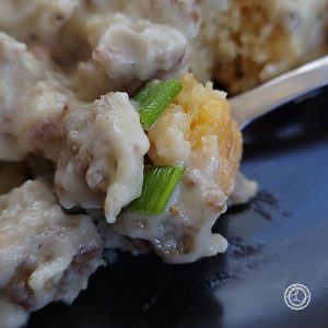 Sausage Gravy for Biscuits and Gravy with a bite on a fork