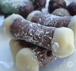 A stack of candies on a plate. A close up