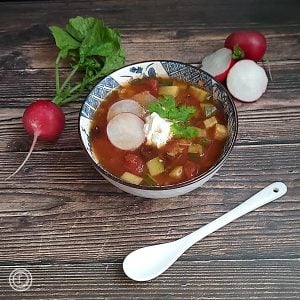 Picture of a bowl of chili with rashies on the sides to decorate.