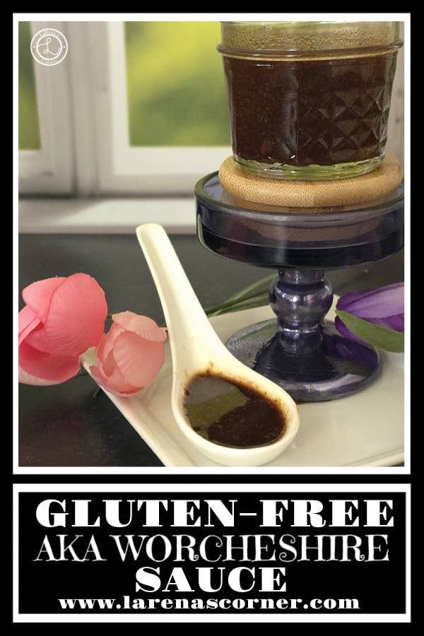 AKA Worcestershire Sauce in a small canning jar with a Chinese Soup spoon full of sauce. Flowers in the background. 