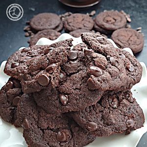Cookies stacked in the background. And a stack of cookies on a platter