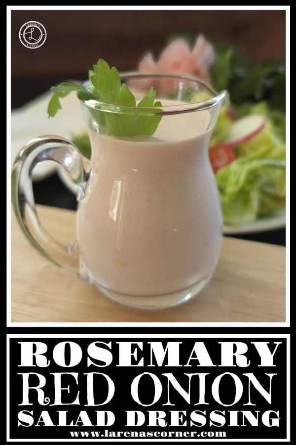 Rosemary Red Onion Dressing in a pitcher in front of a salad. 