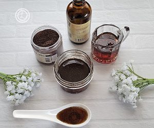 Vanilla Bean Paste on a white countertop with vanilla pod powder, maple syrup, pure Madagascar Vanilla. Surrounded by small white flowers