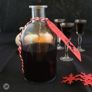 A bottle of Coffee Liqueur with glasses in the background.