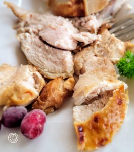 Close-up of a platter of sliced roasted turkey breast.