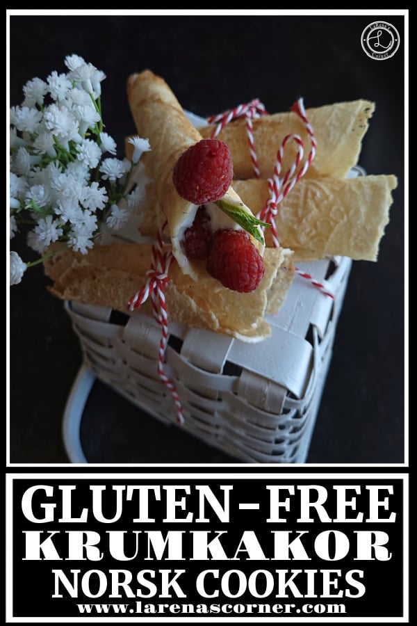 Gluten-Free Krumkakor Norsk Cooies. Three cookies on top oa an upside down basket with some whipped cream and berries inside one cookie and flowers in the background.