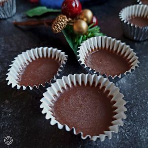 Three Swedish Ice Chocolates with a sprig of holly and berries.