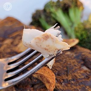A bite of Pan Seared Rosemary Sage Halibut on a fork