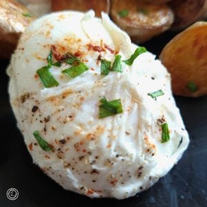 A close up of One Poached Egg on a plate.