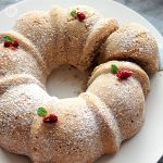 Gluten-Free Swedish Spice Cake Recipe 09 Gluten-Free Swedish Spice Cake on a plate topped with powdered monk fruit sweetener and dried lingonberries and sprigs of mint.