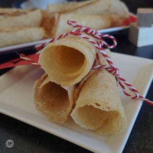 A close up of a stack of three cookies each tied with a string.