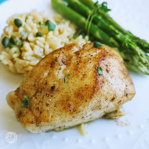 Jalapeno Chilean Sea Bass with fried cauliflower rice and asparagus tied with a little thyme.