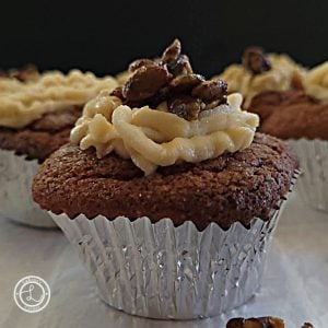 Gluten-Free Pumpkin Mascarpone Muffins. A close up view of one with more in the background.